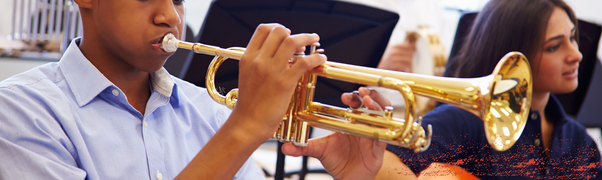 student in band playing trumpet
